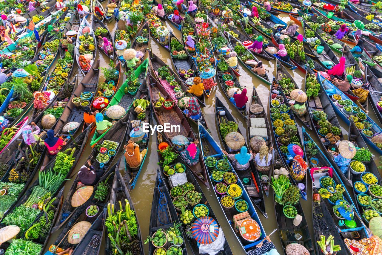 High angle view of vendors in boat on floating market