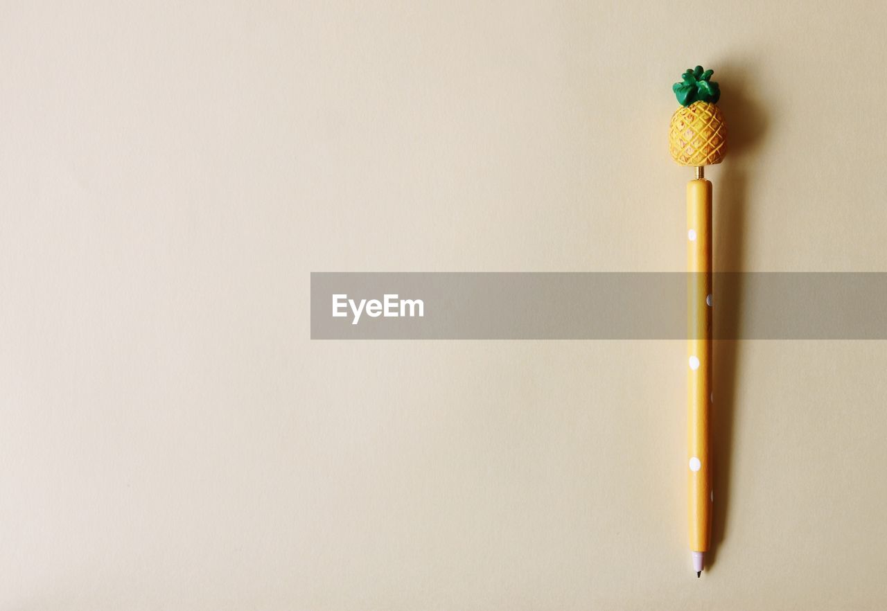 indoors, copy space, studio shot, no people, yellow, still life, pencil, single object, close-up, writing instrument, white background