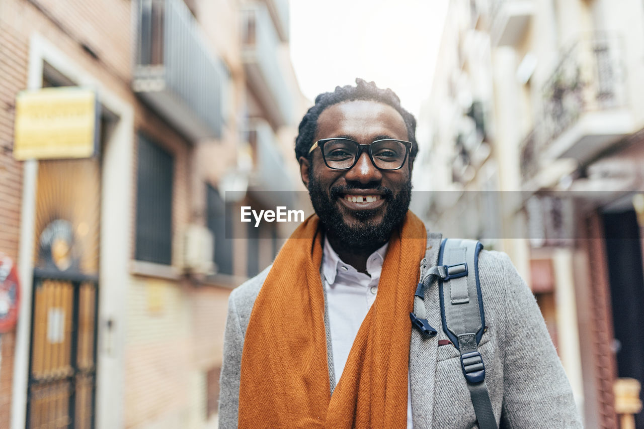 Portrait of businessman wearing eyeglasses while standing in city