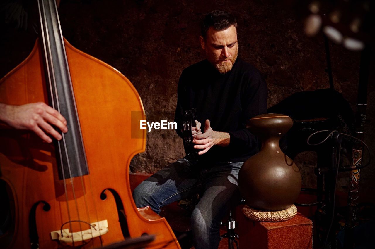 Musicians playing musical instruments in room