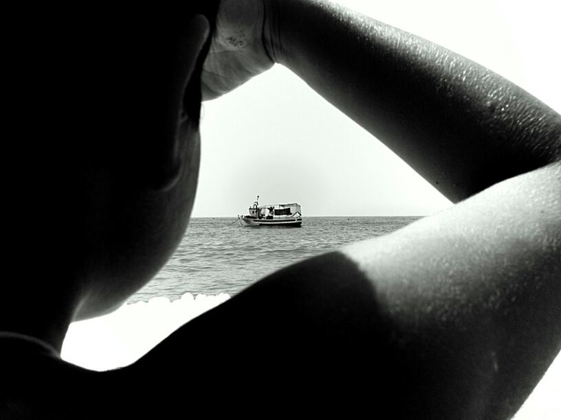 CROPPED IMAGE OF WOMAN STANDING ON SEA