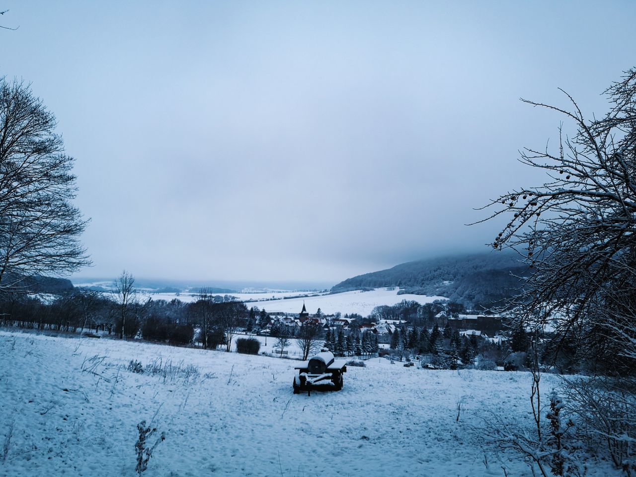 SNOW COVERED LAND AGAINST SKY