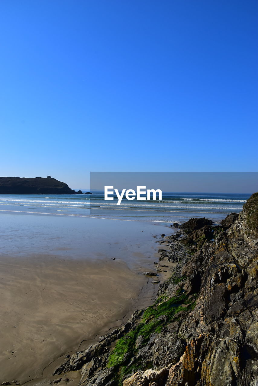 SCENIC VIEW OF BEACH AGAINST CLEAR SKY