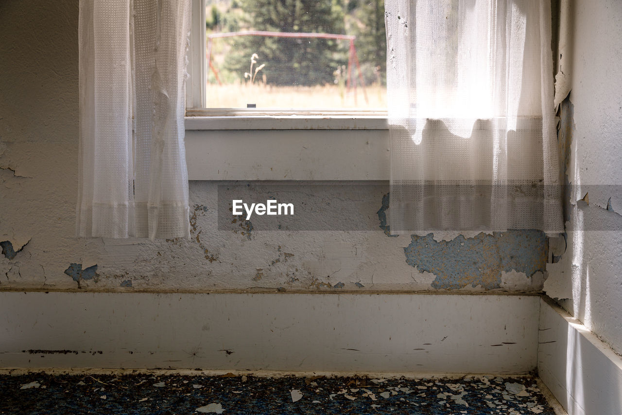 Curtain on window in abandoned house