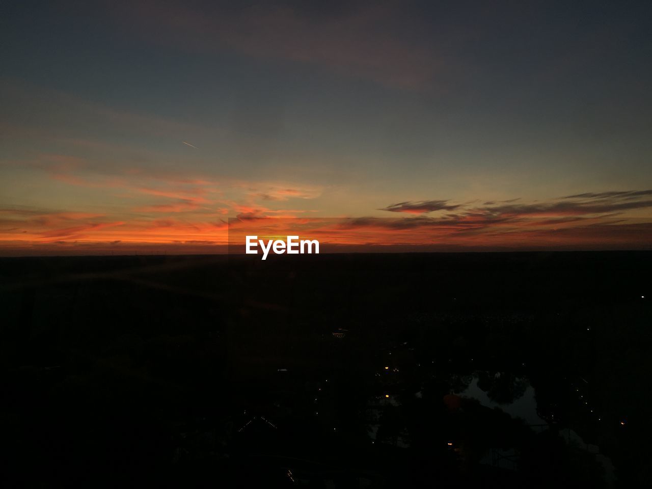 Scenic view of landscape against sky at sunset