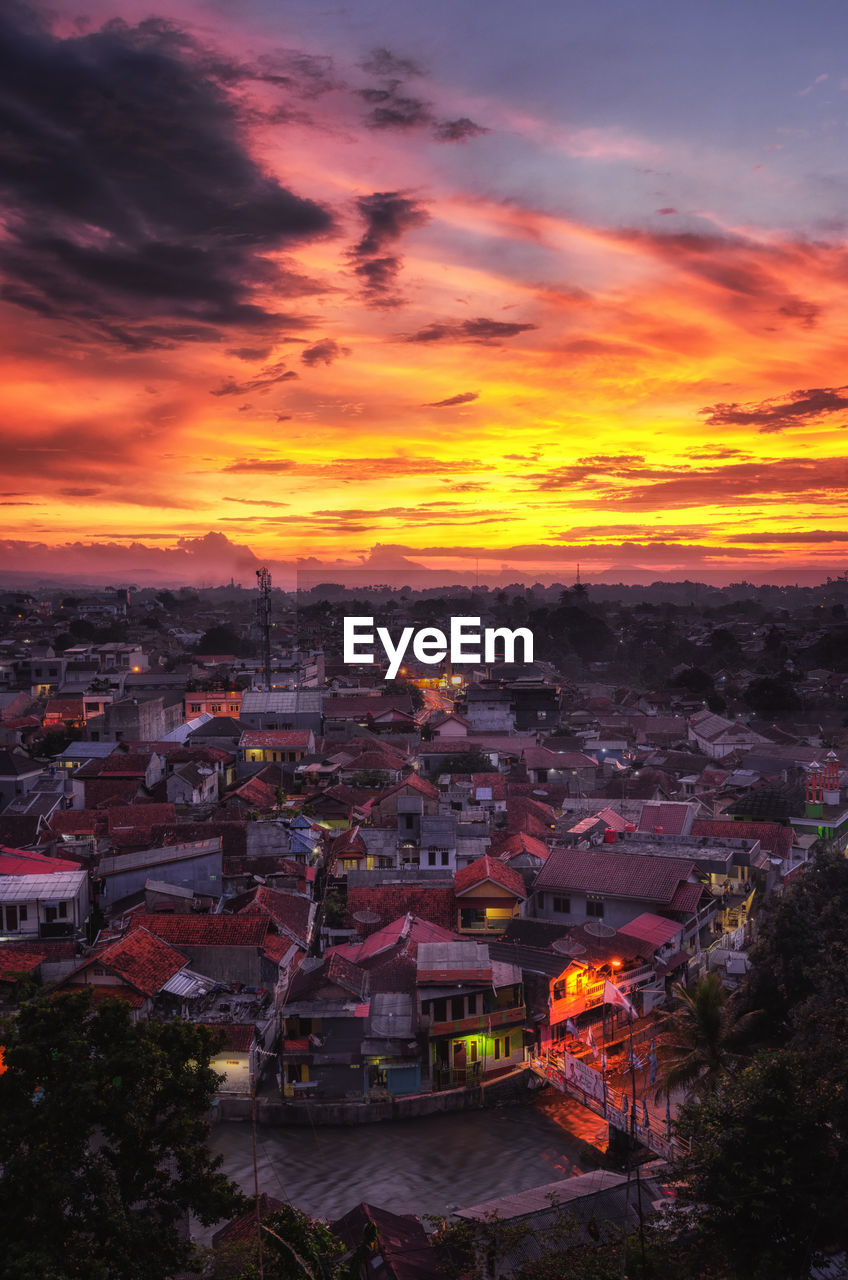 High angle view of illuminated buildings against sky during sunset