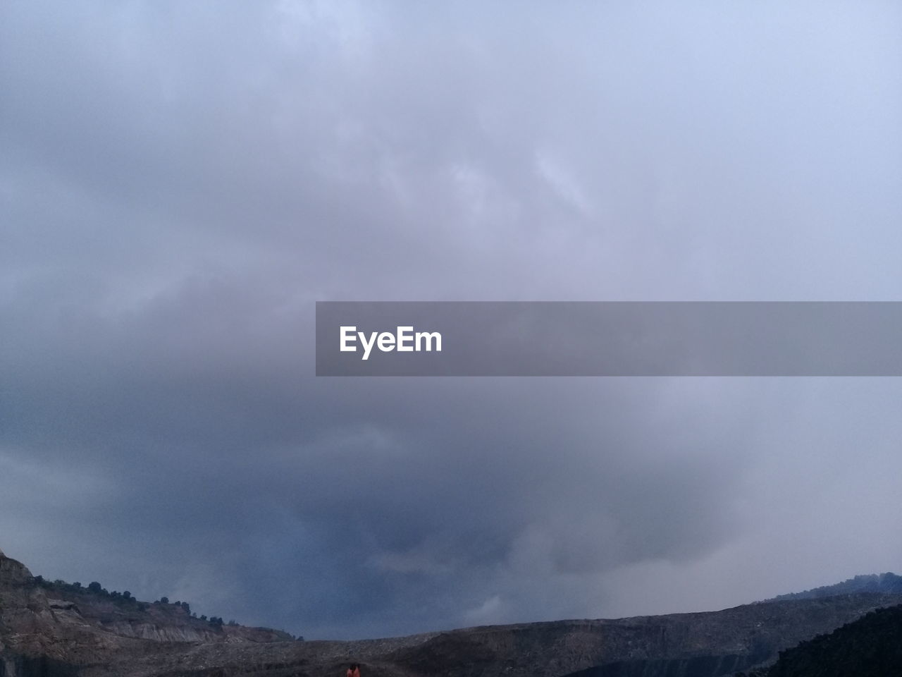 LOW ANGLE VIEW OF CLOUDY SKY OVER MOUNTAIN