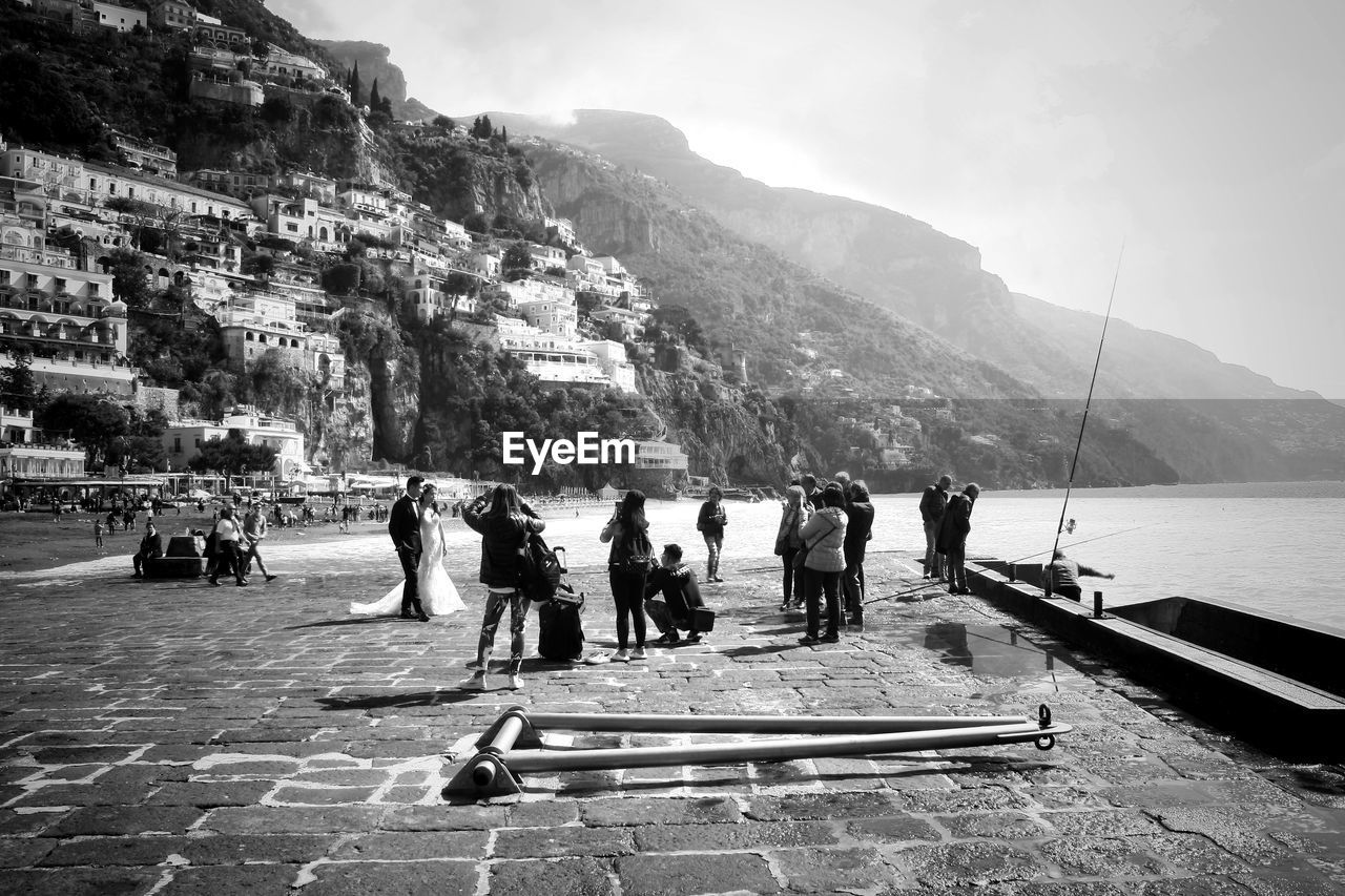 Group of people shooting a marriage against sky of posillipo