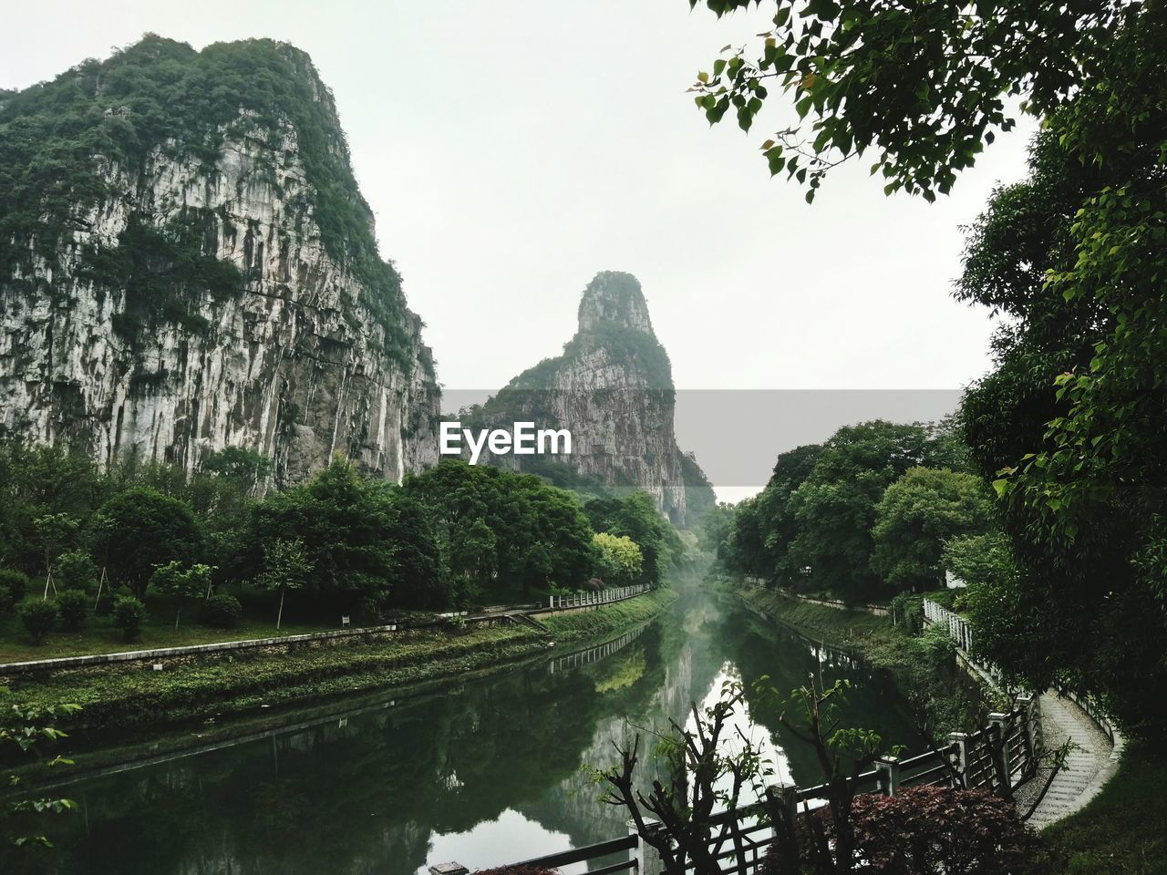 Scenic view of rocks and trees against sky