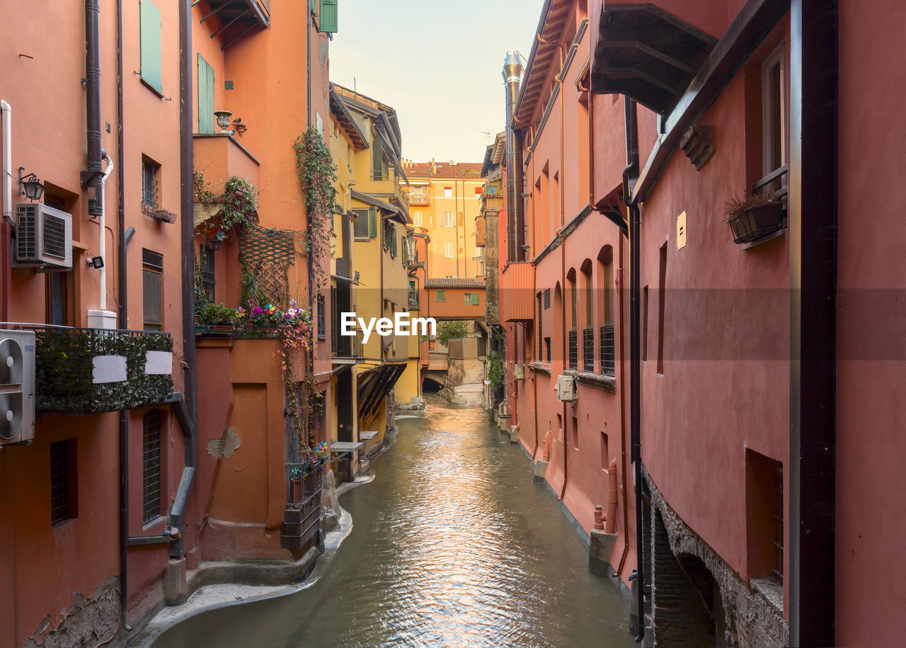 NARROW CANAL AMIDST BUILDINGS