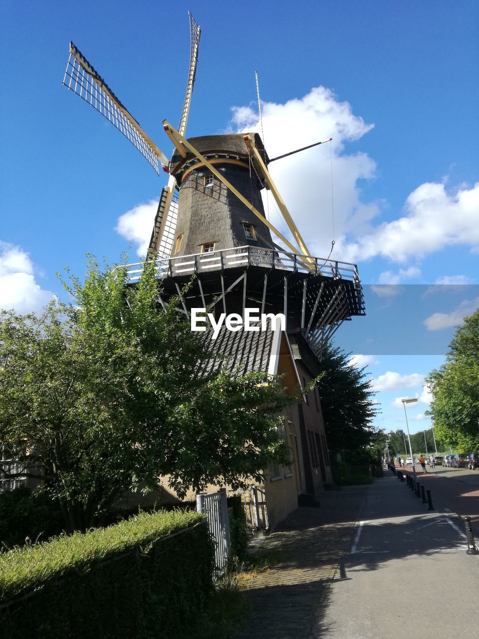 Low angle view of traditional windmill against sky