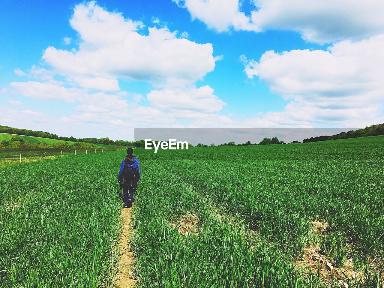 Woman walking on agricultural field