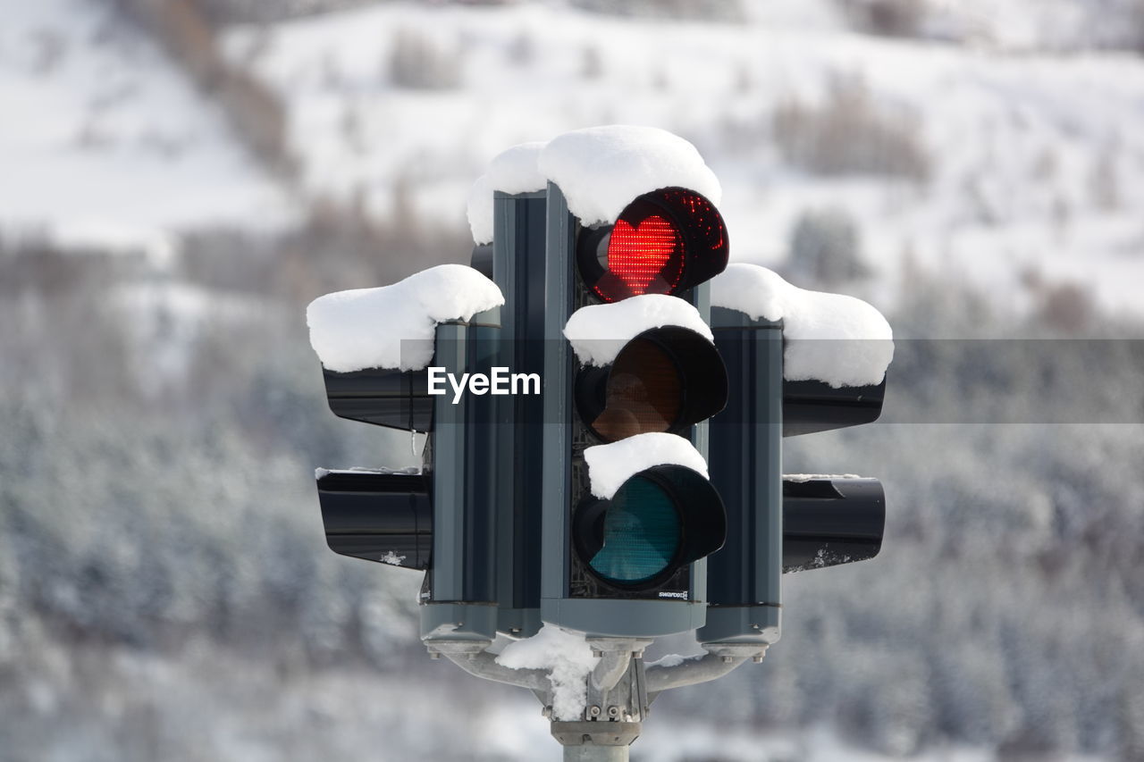 Road sign on snow covered street light