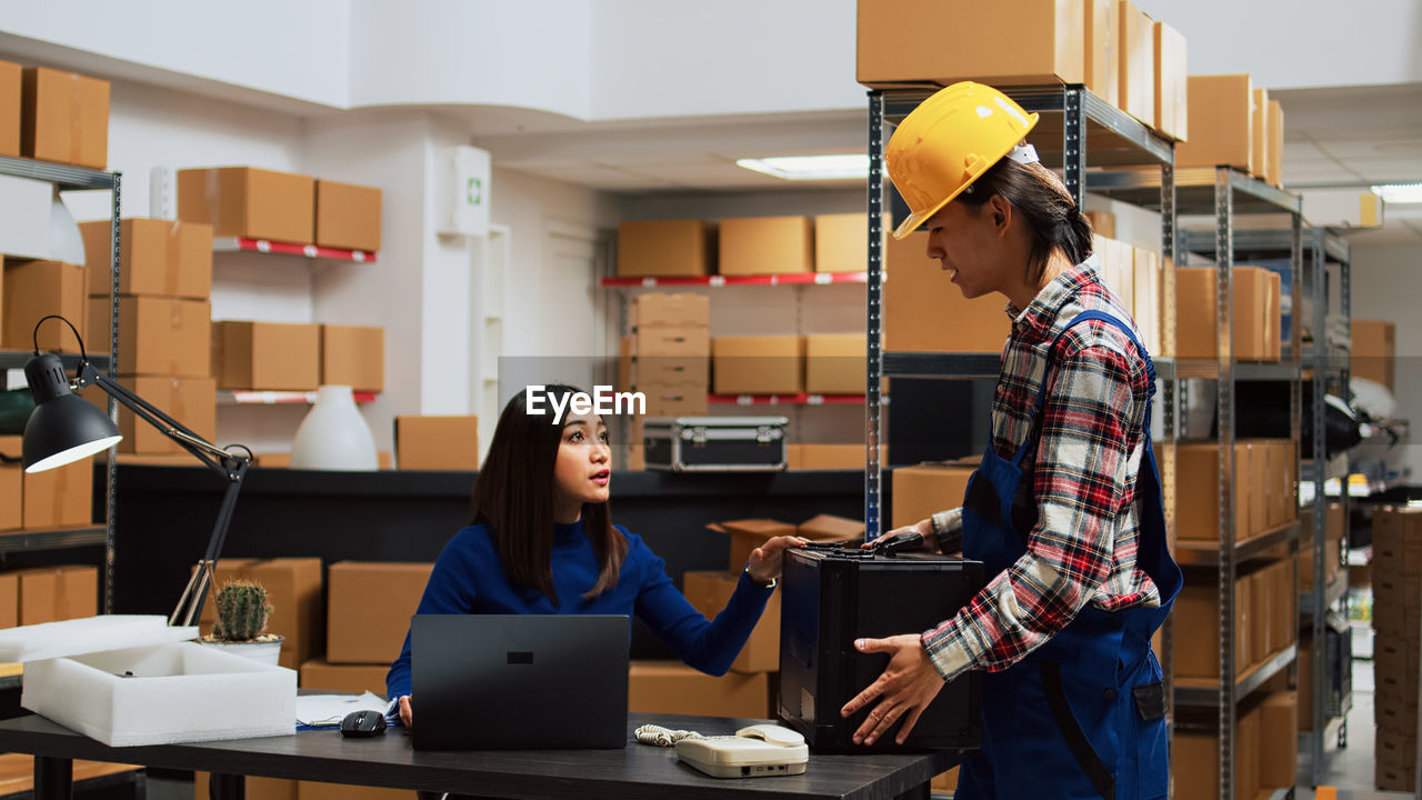 side view of man using laptop at office