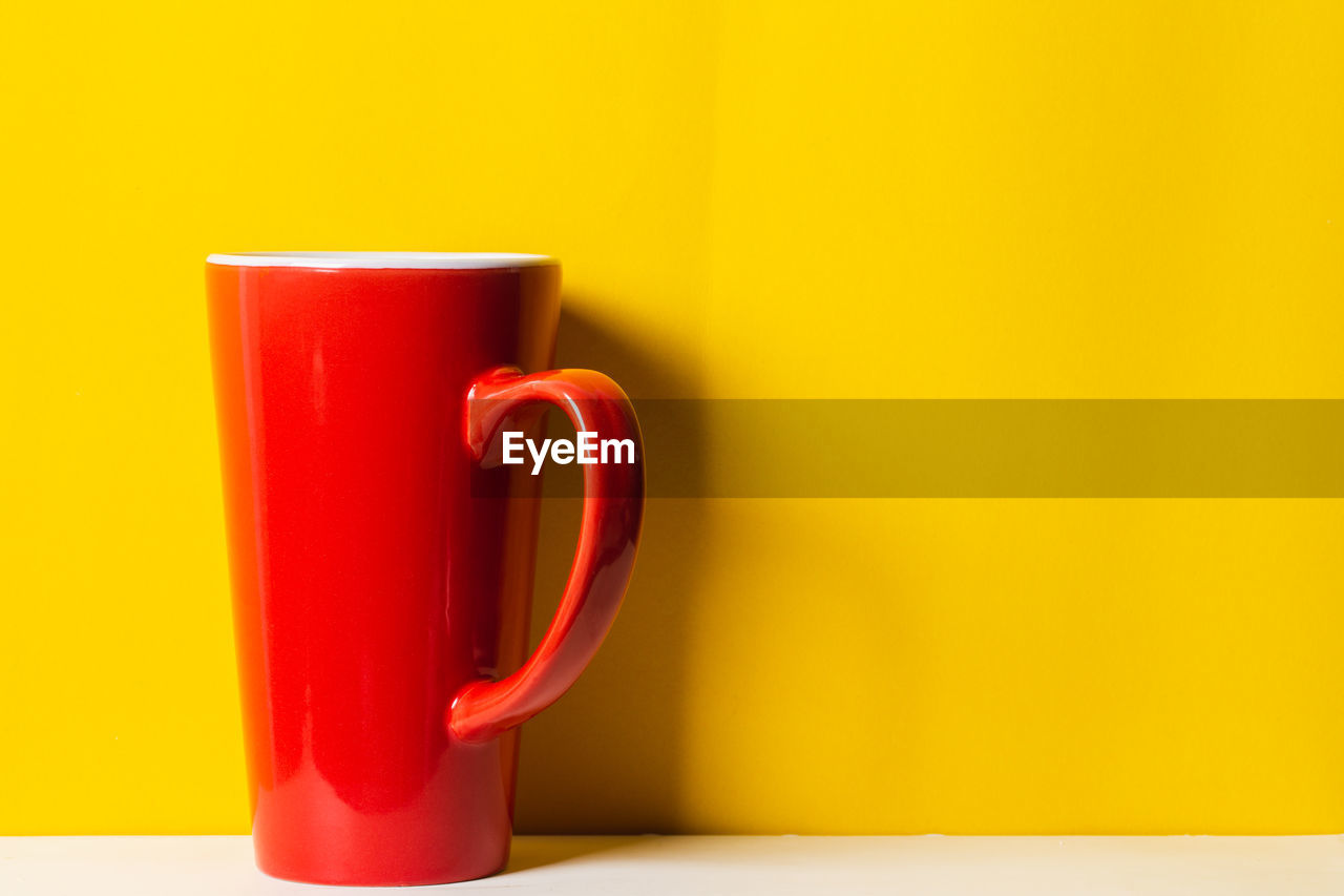 Red cup on yellow background