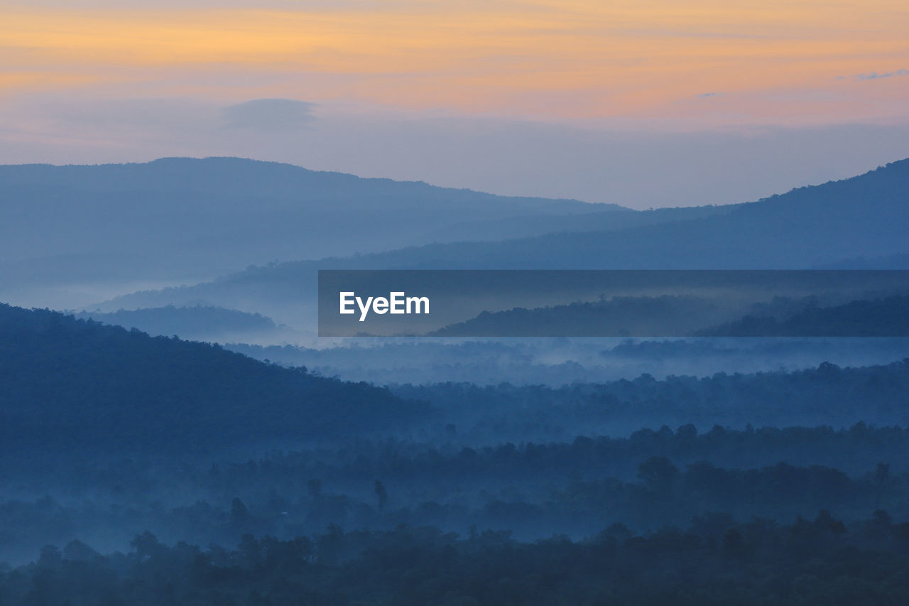 Scenic view of mountains against sky during sunrise