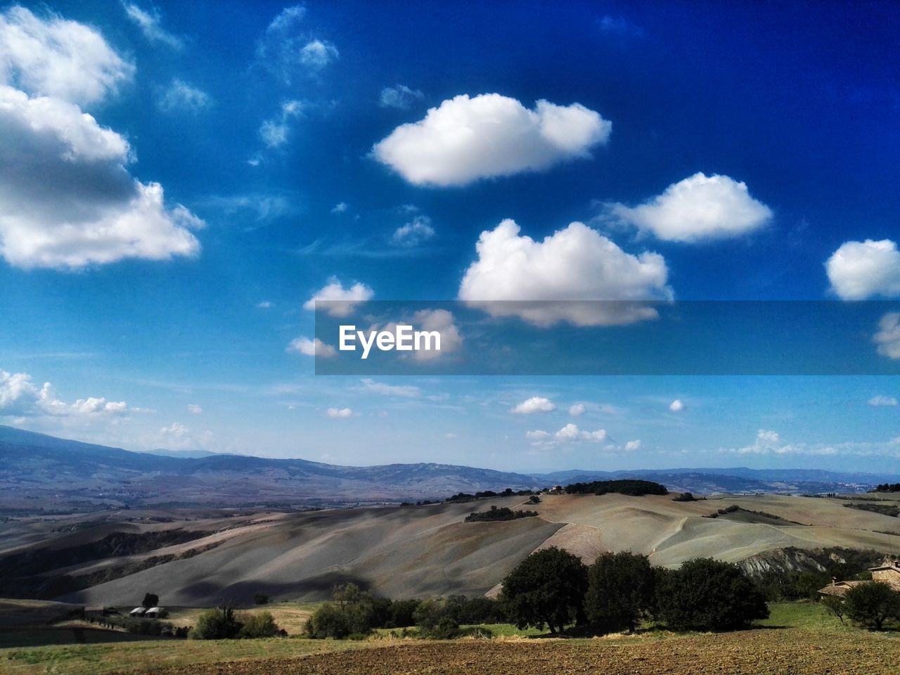 SCENIC VIEW OF LANDSCAPE AGAINST BLUE SKY