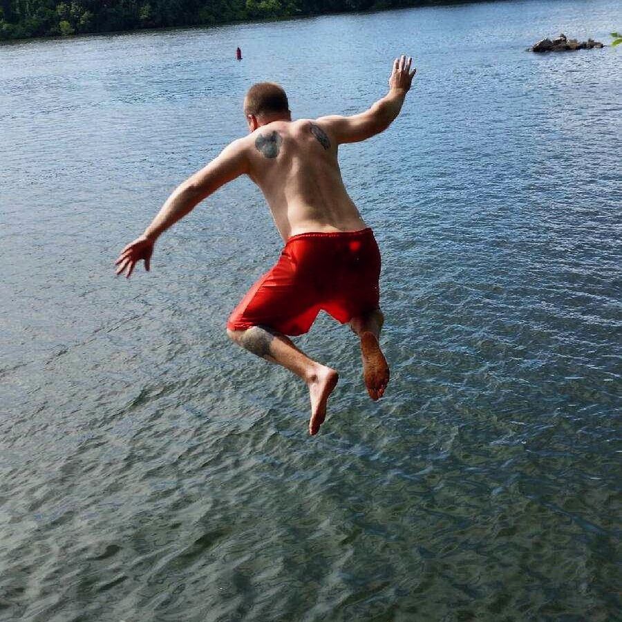 REFLECTION OF WOMAN JUMPING IN WATER