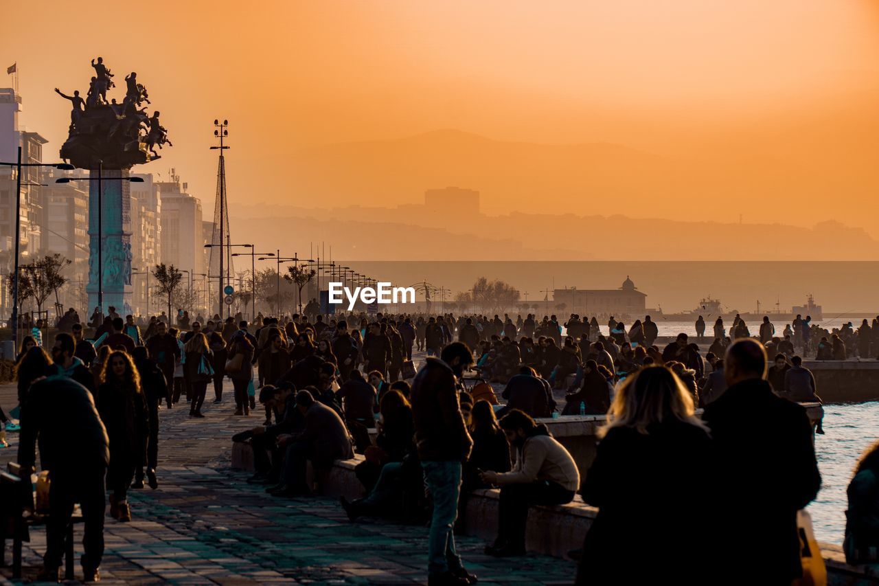 Crowd at town square during sunset