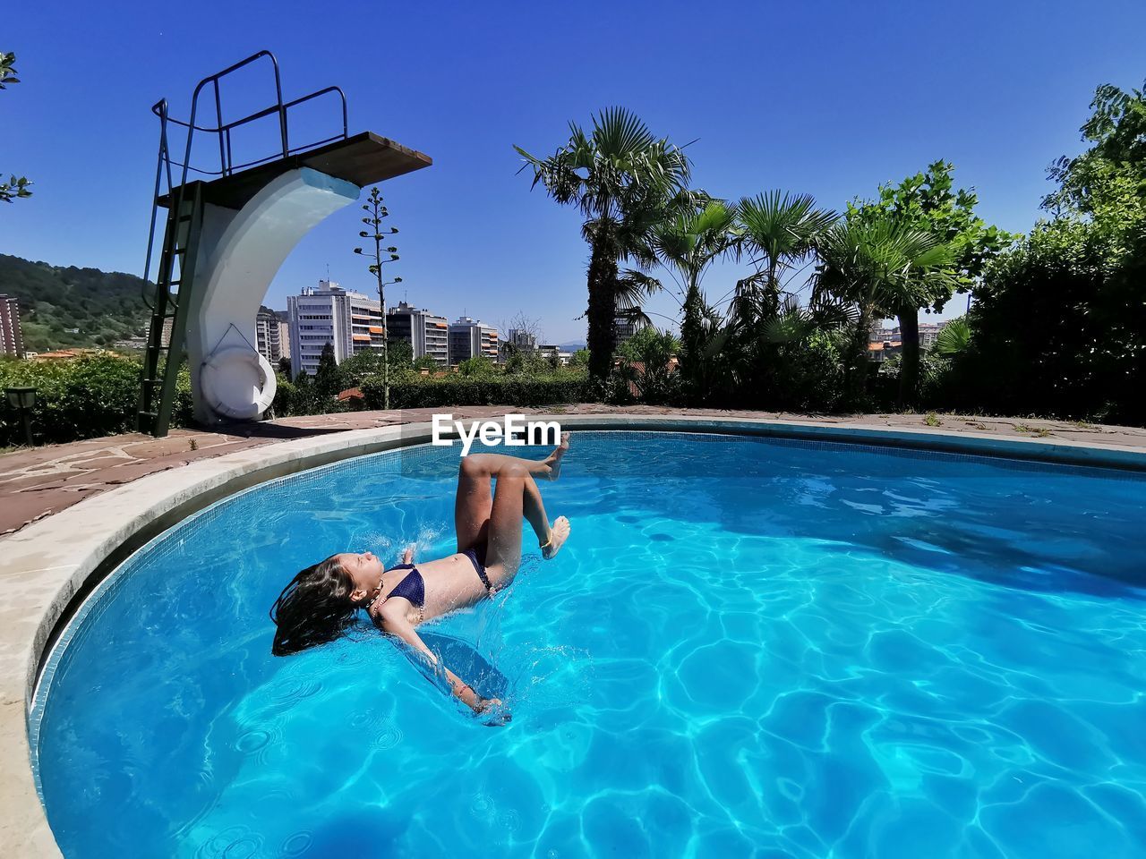 Girl wearing bikini swimming in pool