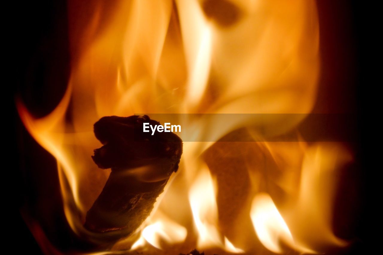 Close-up of fire wood against black background