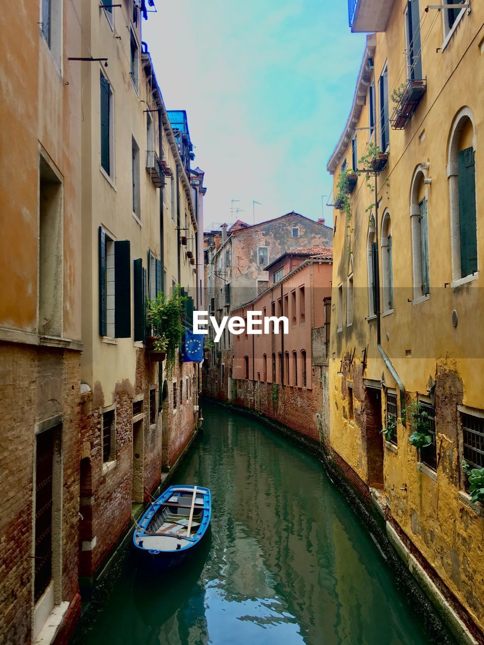 Canal passing through buildings in city