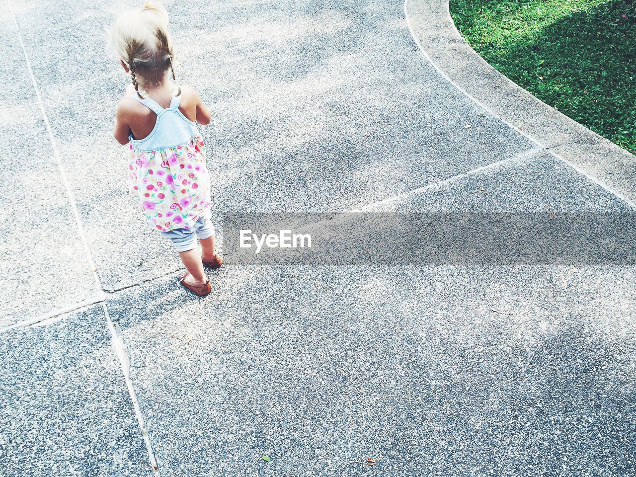 Close-up of child on footpath