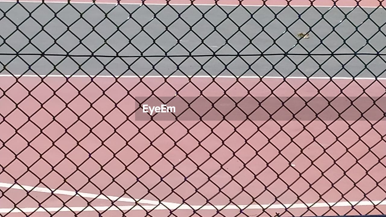 Full frame shot of chainlink fence against sky