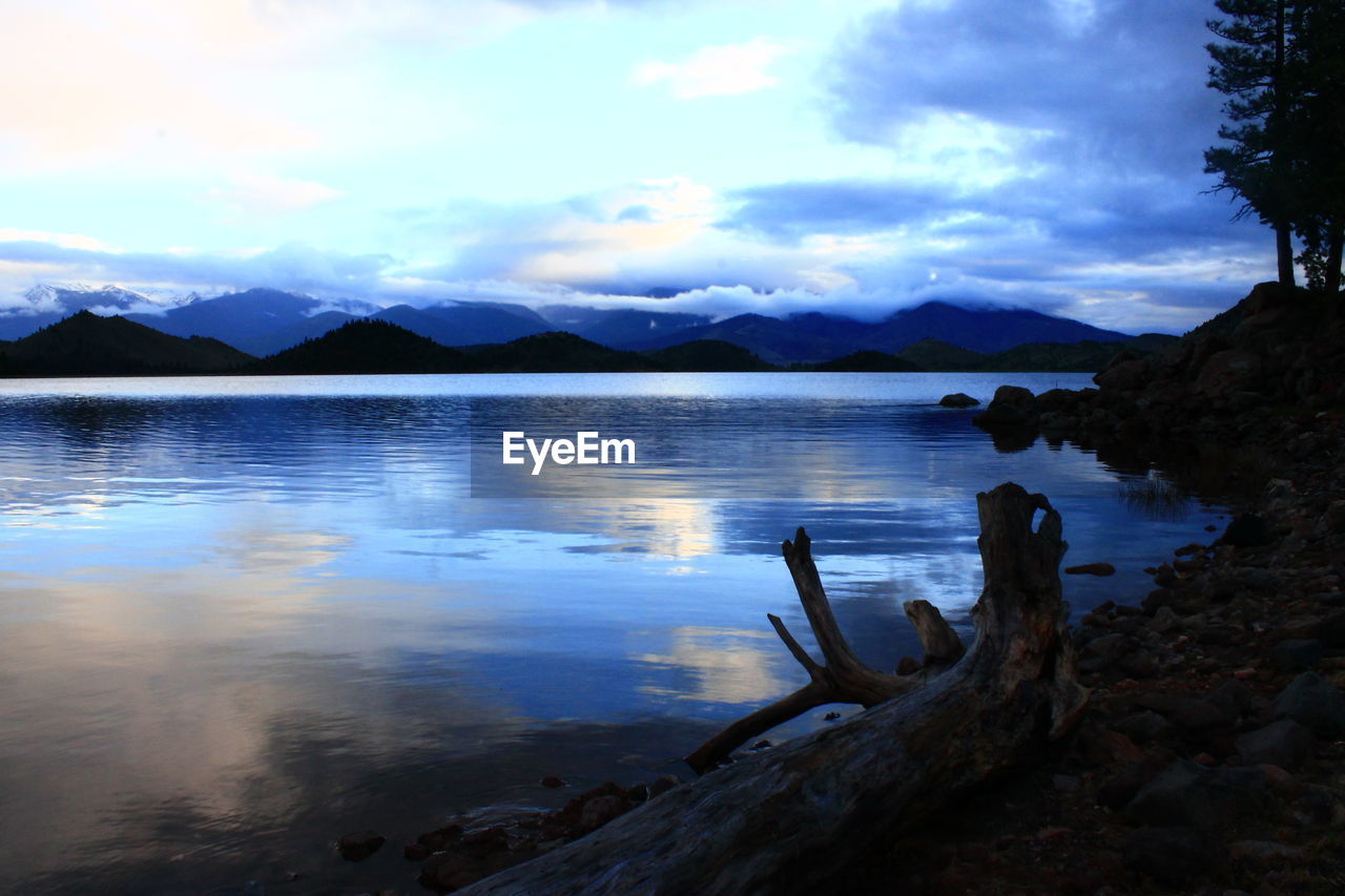 SCENIC VIEW OF LAKE WITH MOUNTAINS IN BACKGROUND