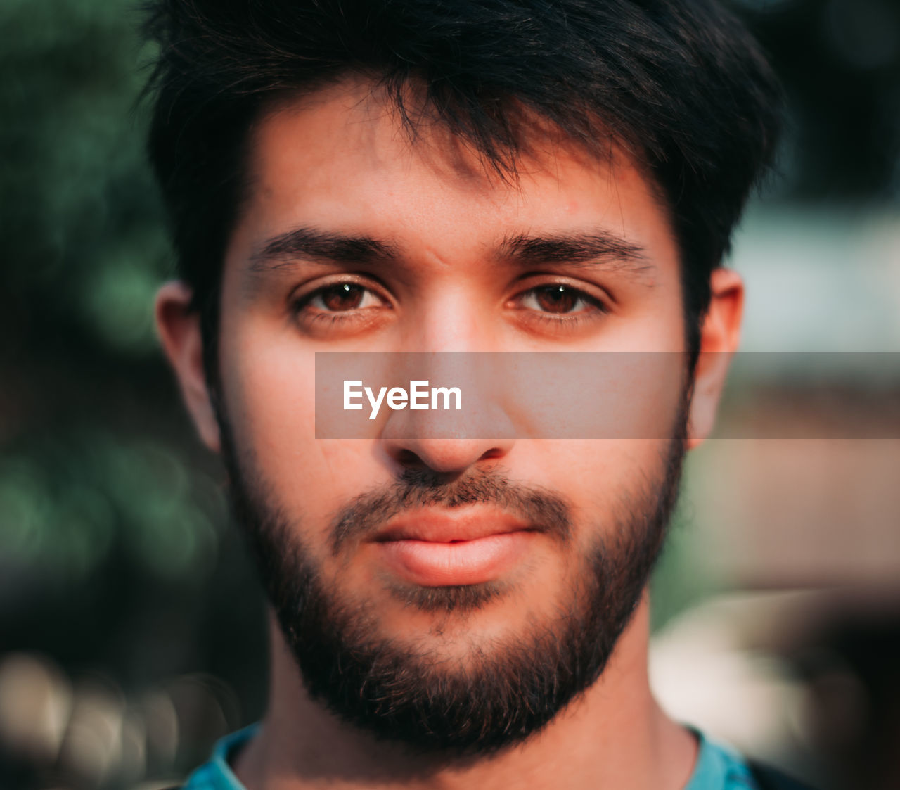 Close-up portrait of young man with hunny brown eyes and beard