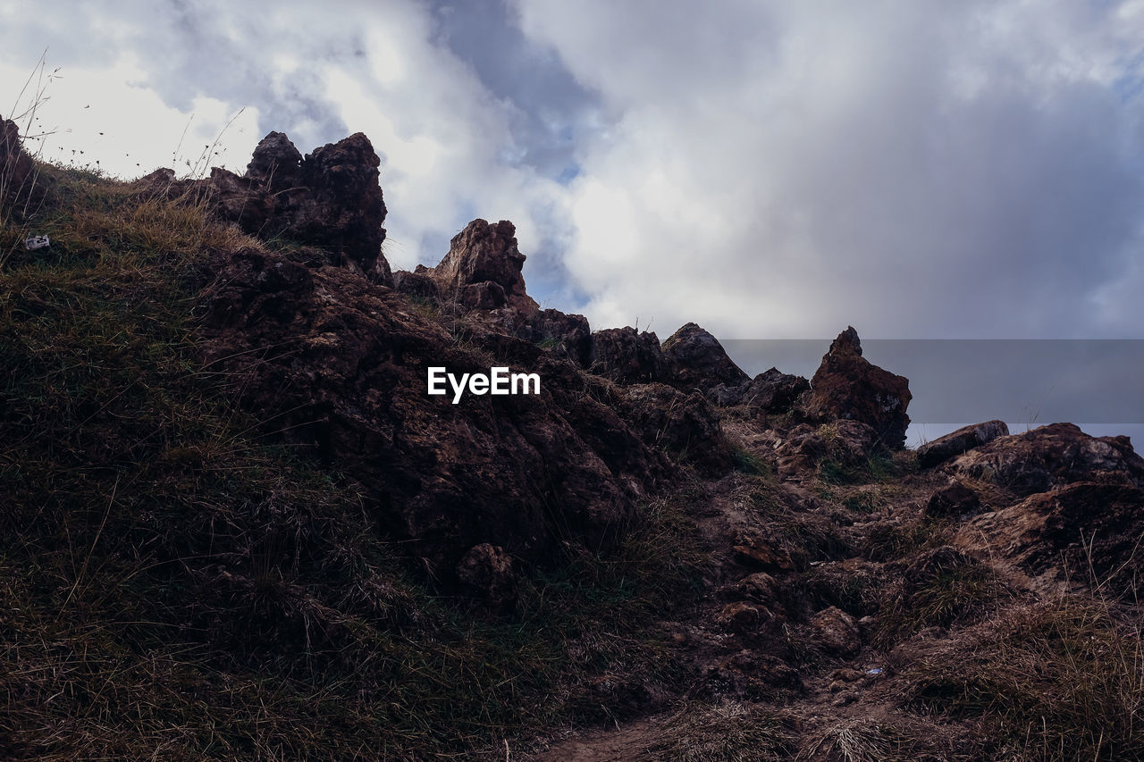 Low angle view of rocks against sky