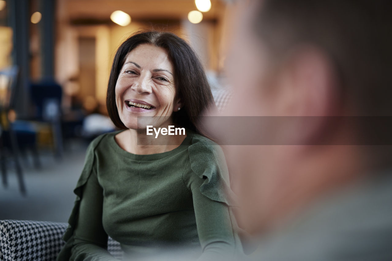 Mature woman looking at man and smiling