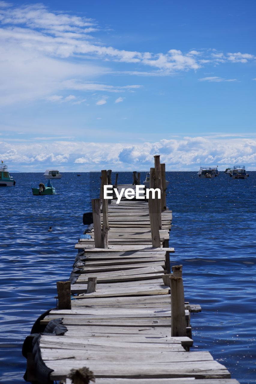 water, sky, sea, nature, ocean, shore, pier, reflection, cloud, blue, beauty in nature, dock, scenics - nature, wood, tranquility, coast, day, jetty, tranquil scene, land, no people, outdoors, beach, nautical vessel, vehicle, body of water, vacation, architecture, non-urban scene, horizon, the way forward, bay, transportation, idyllic, travel destinations, travel, sunlight