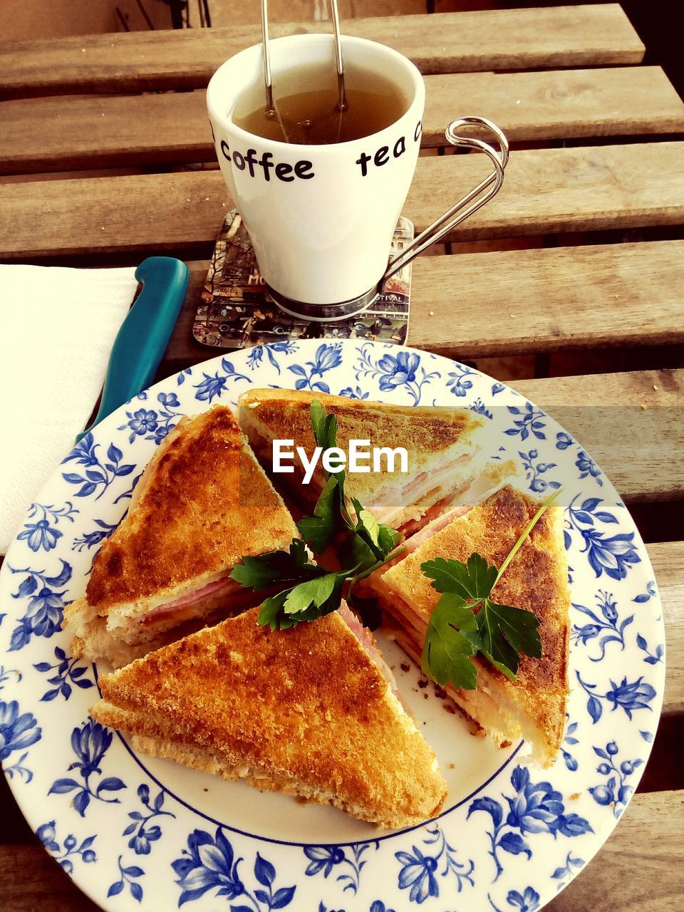 Close-up of toast on plate and mug of tee on table