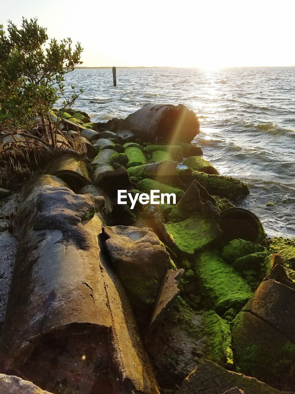 SCENIC VIEW OF SEA WITH ROCKS IN BACKGROUND