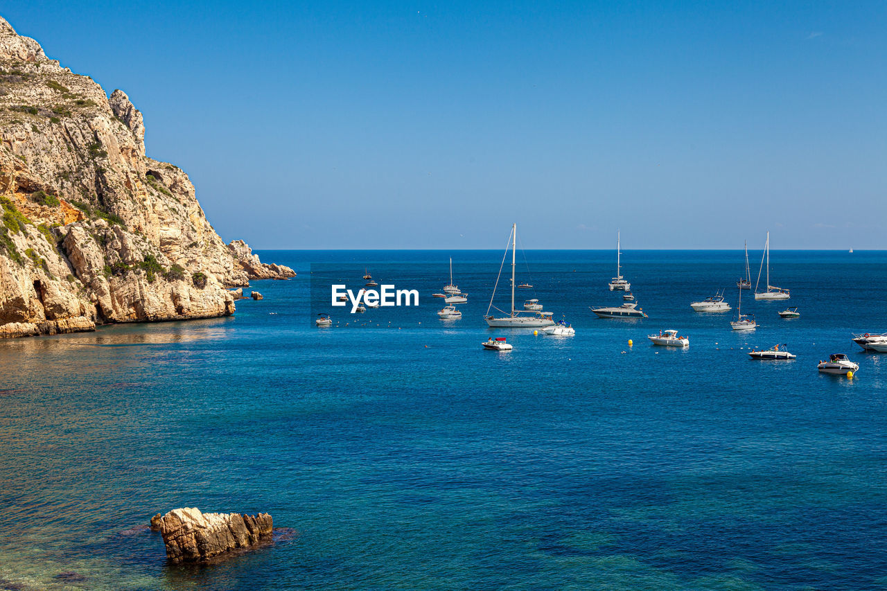 Scenic view of sea against clear blue sky