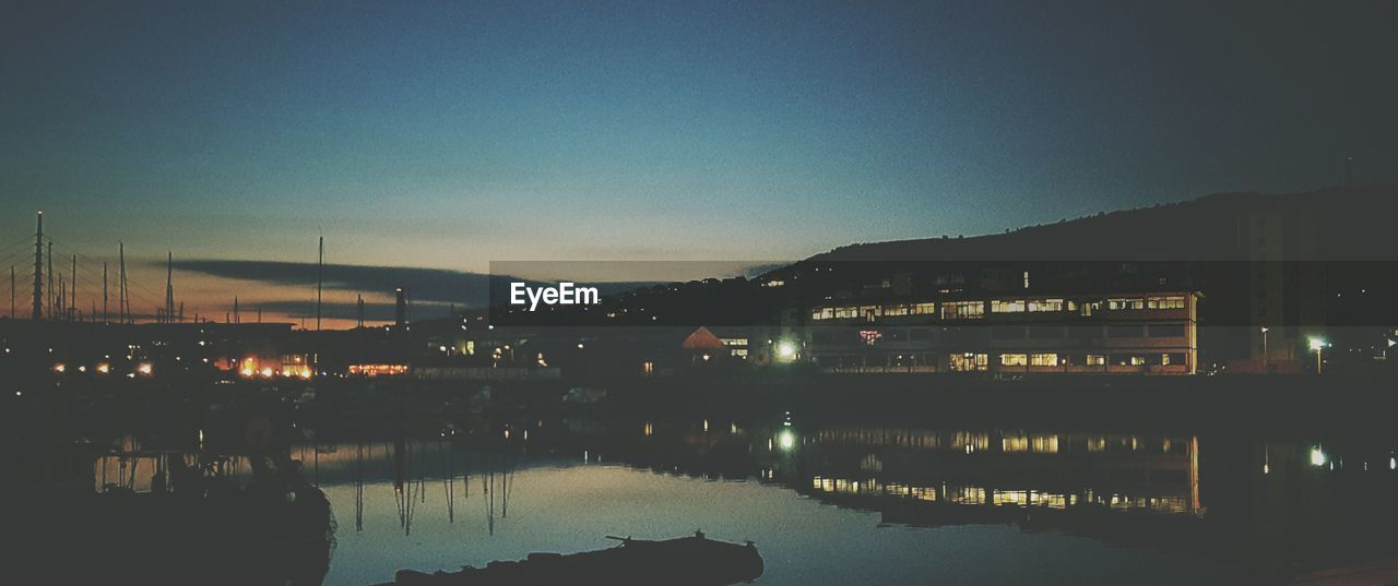 View of boats on harbor at night