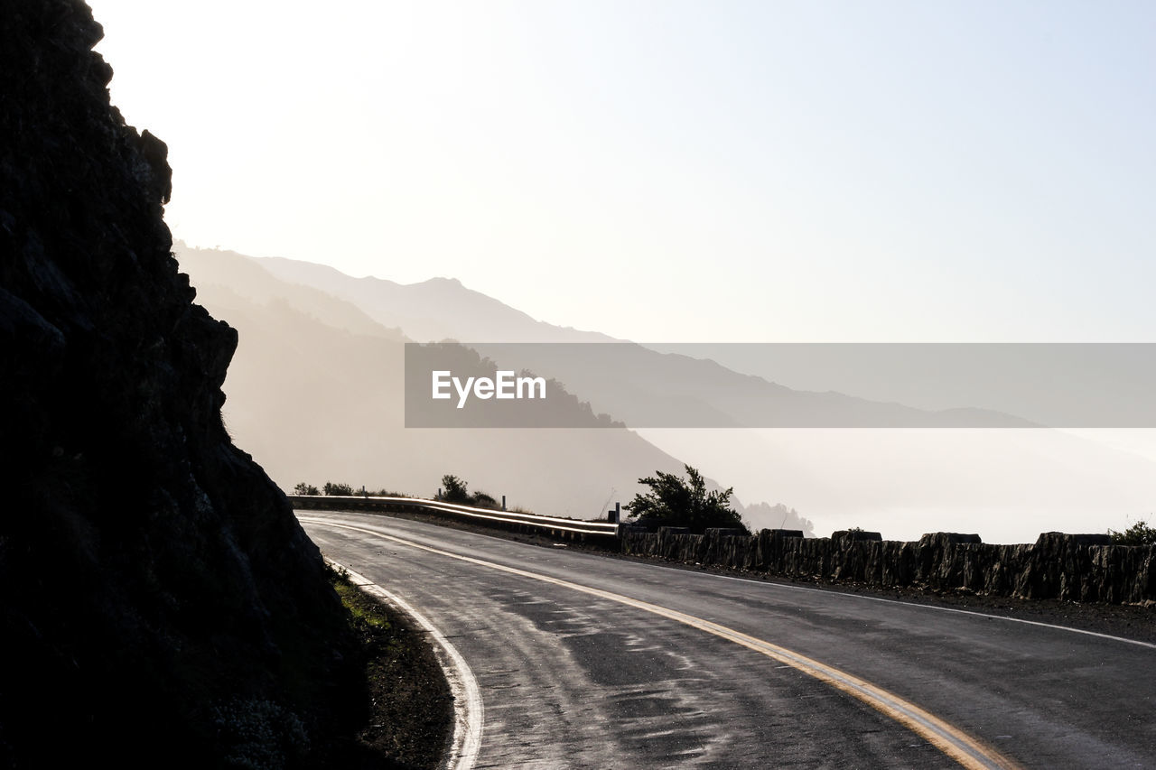 Road on mountains against clear sky