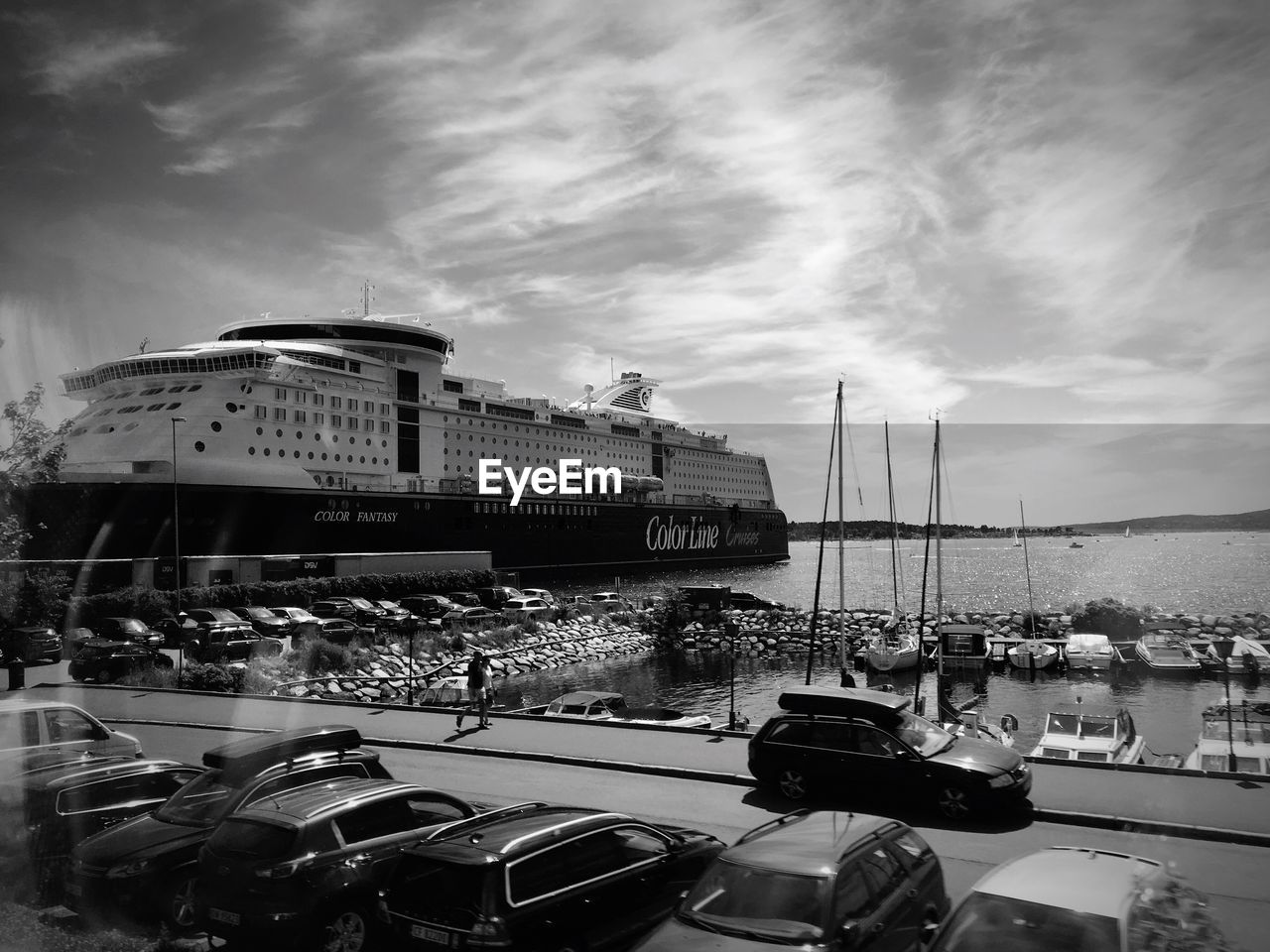 BOATS MOORED AT HARBOR AGAINST SKY