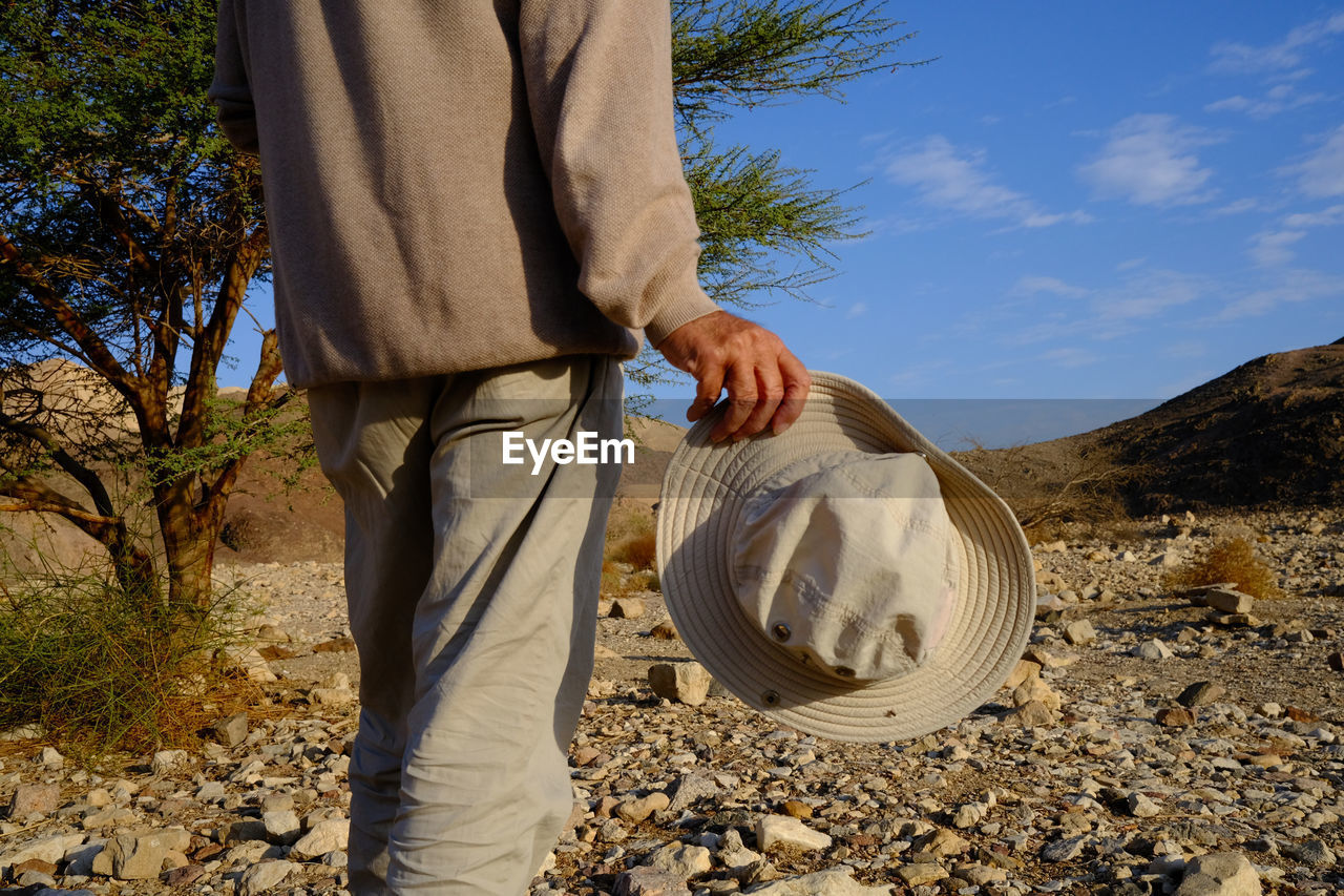 Rear view of senior man standing in the desert 