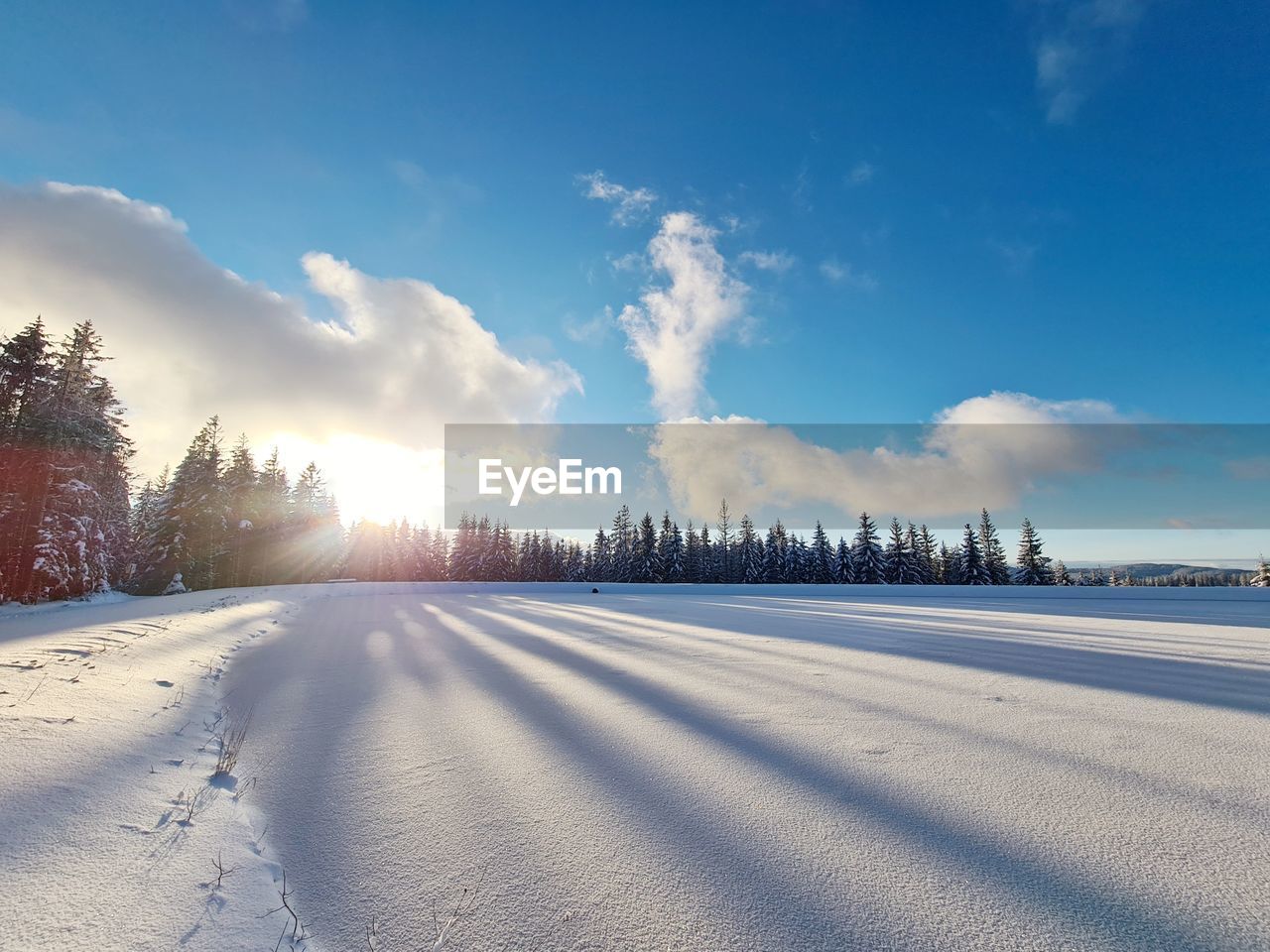 Snow covered land against sky