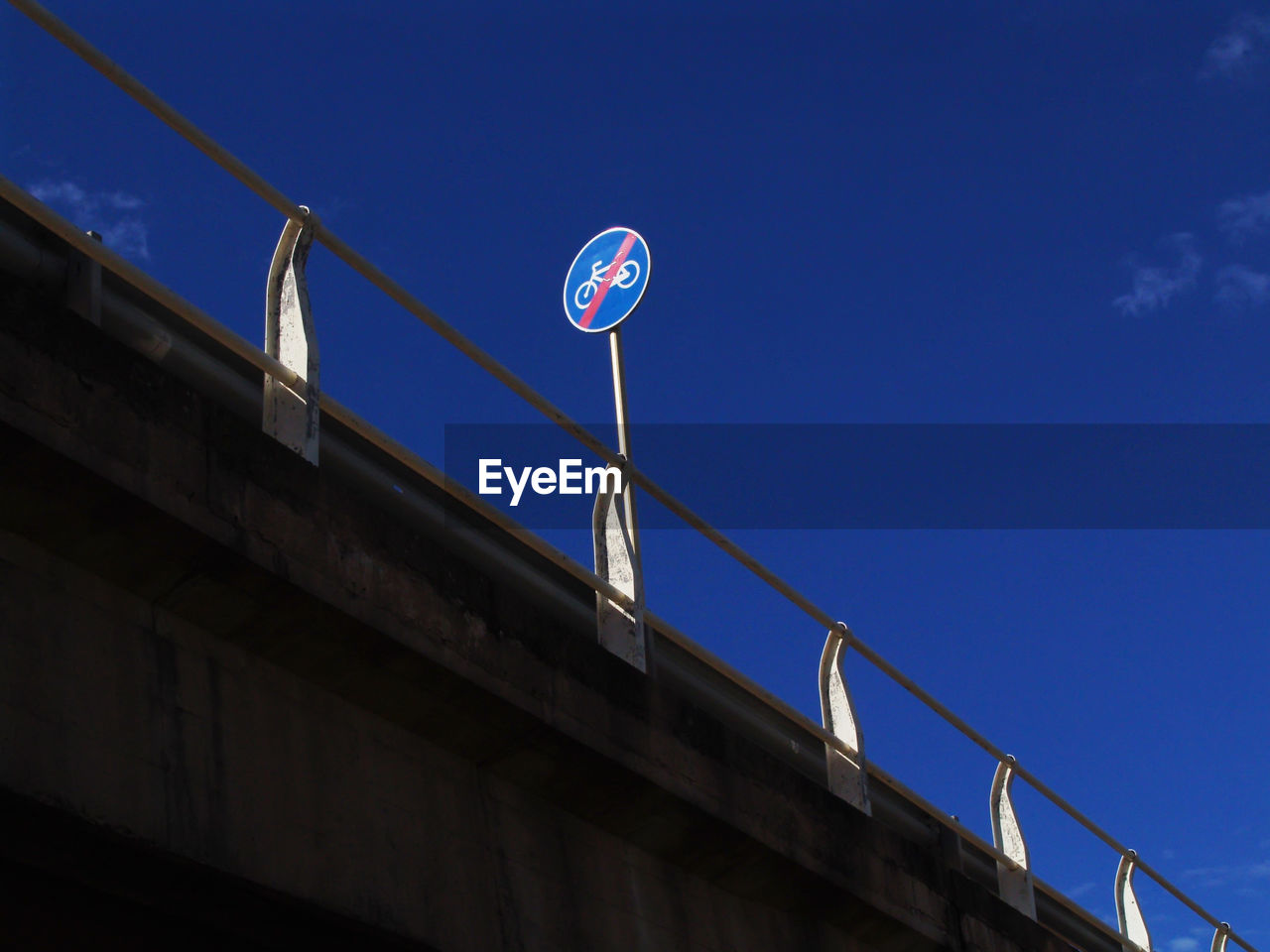 Low angle view of road sign on bridge