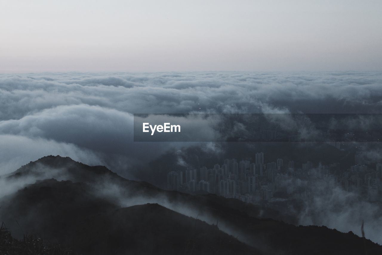 Scenic view of mountains against cloudy sky