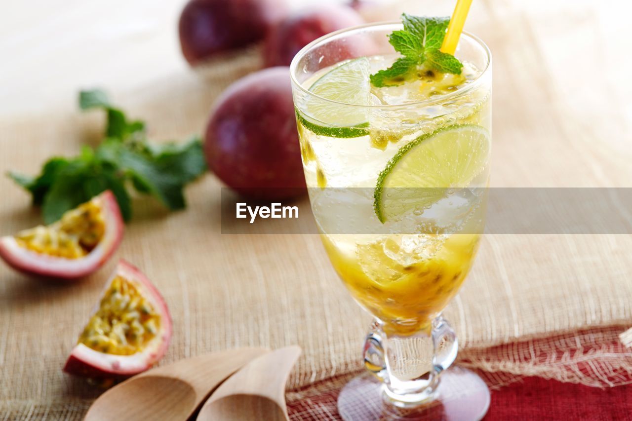 CLOSE-UP OF COCKTAIL WITH JUICE ON TABLE