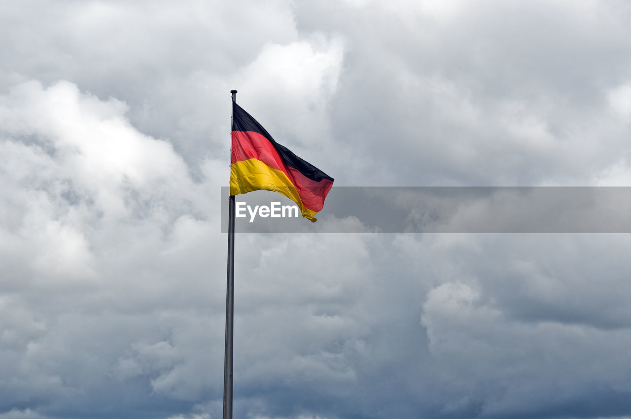 German flaf in a cloudy sky, berlin, germany