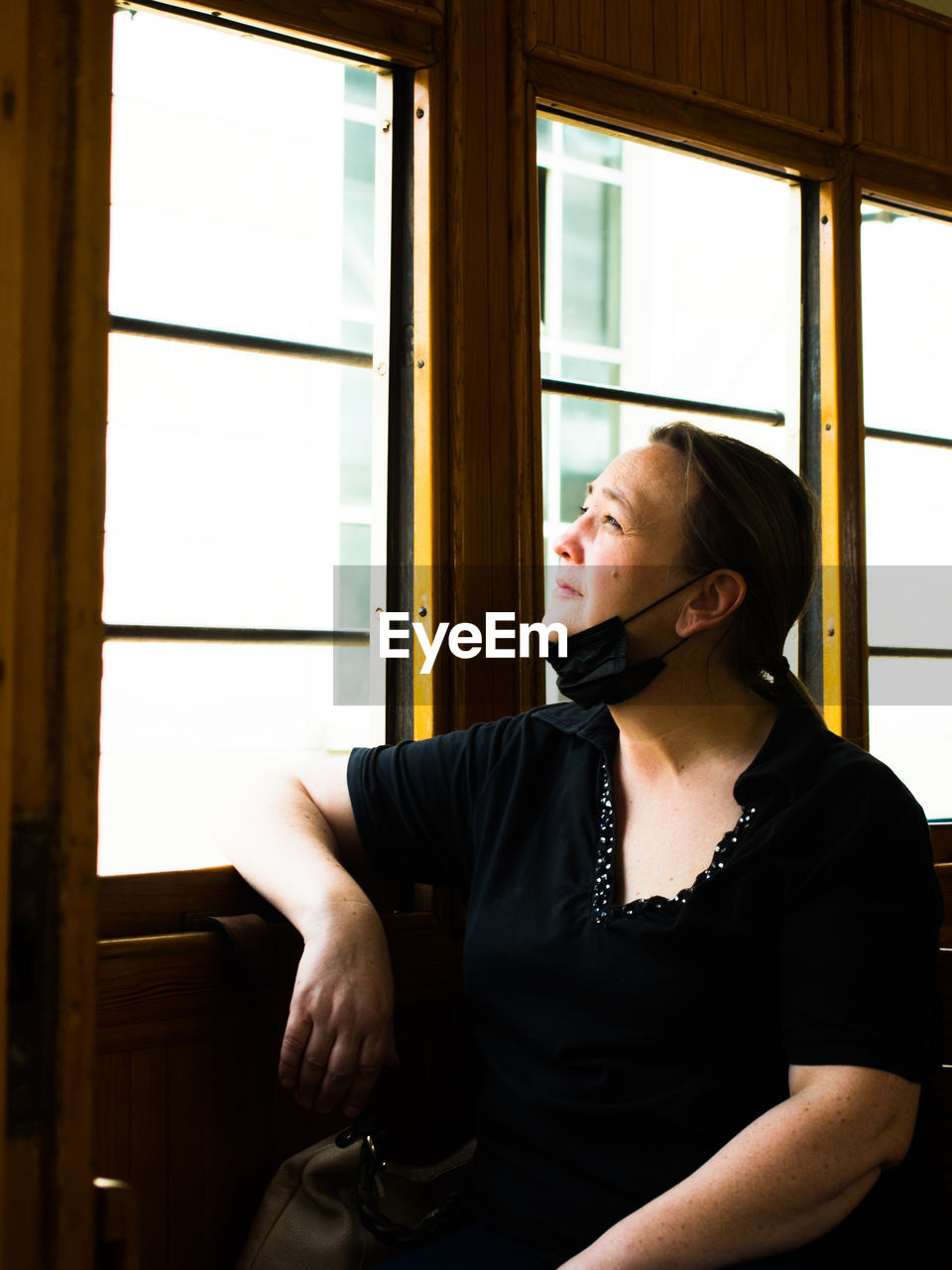  woman looking through train window 