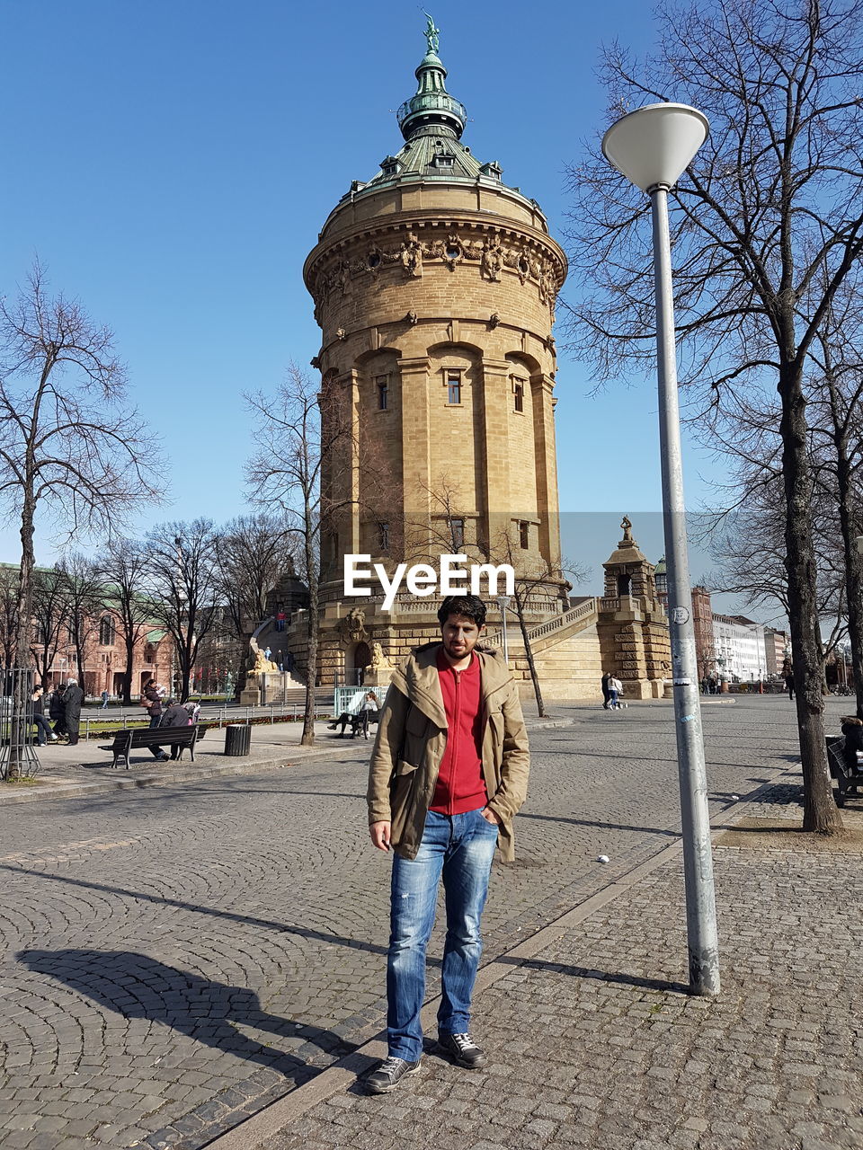 PEOPLE IN FRONT OF CLOCK TOWER AGAINST SKY