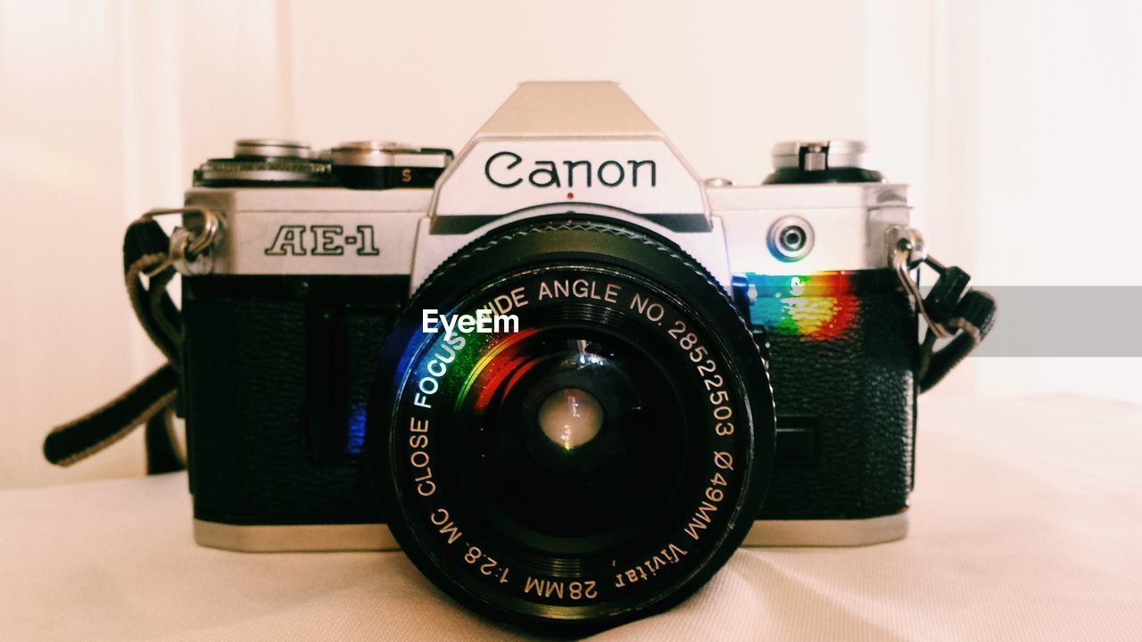 CLOSE-UP OF VINTAGE CAMERA ON TABLE WITH TEXT