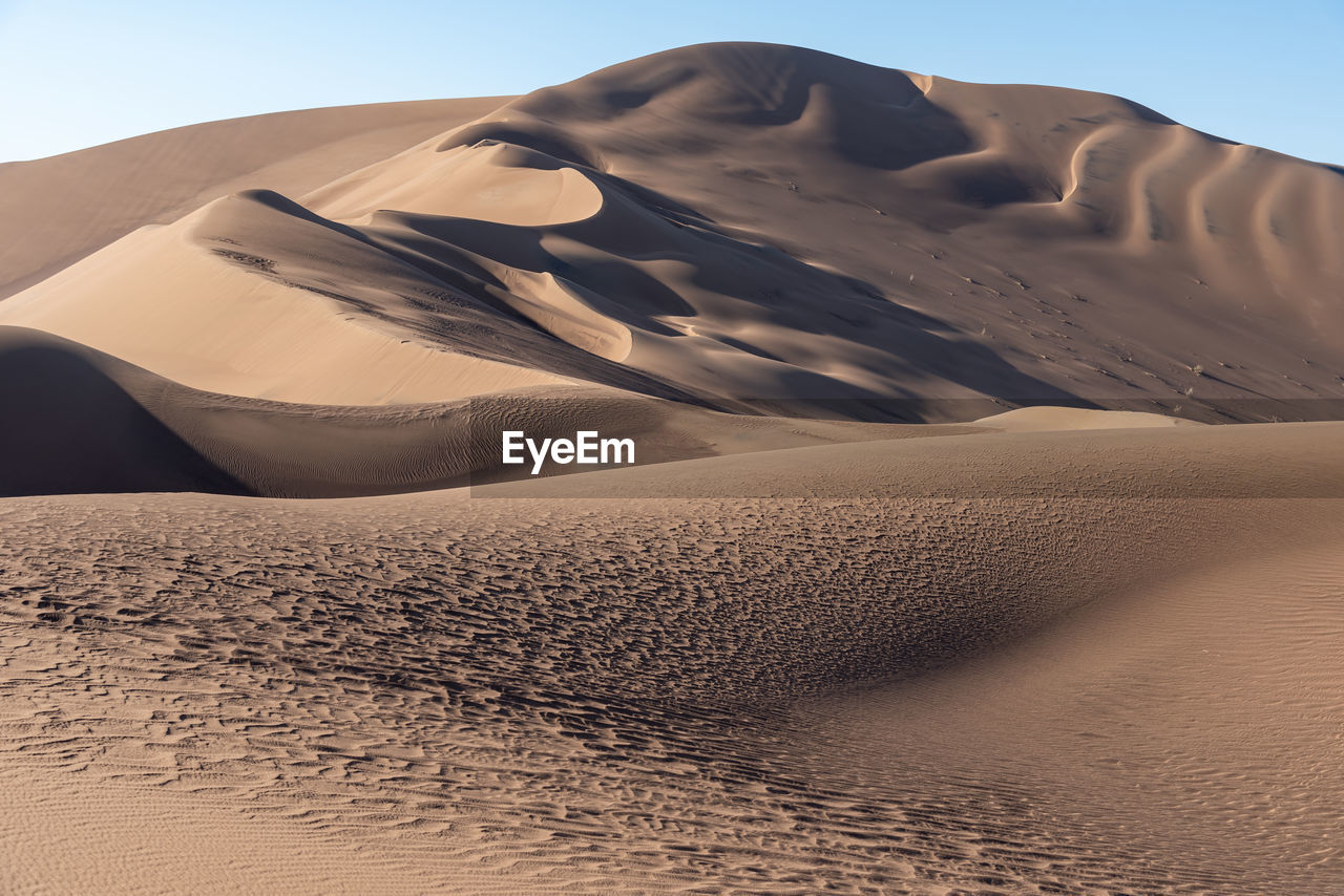 The formation of sands in dasht e lut or sahara desert with waved sand pattern on sand dune. 