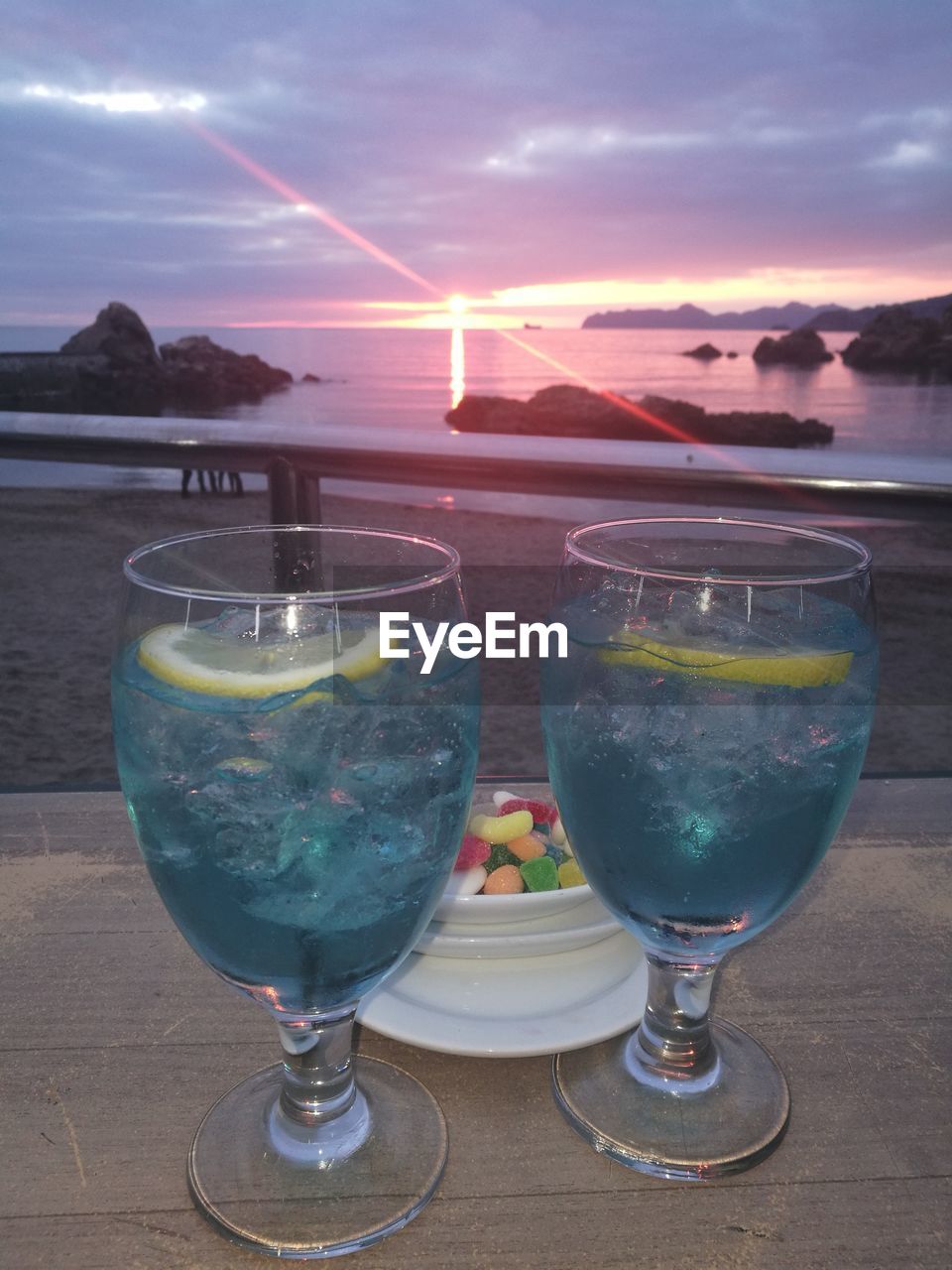 CLOSE-UP OF WINE GLASSES AGAINST SKY